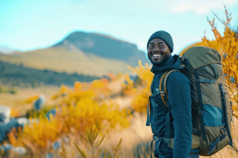 African man hiking backpacking mountain autumn.