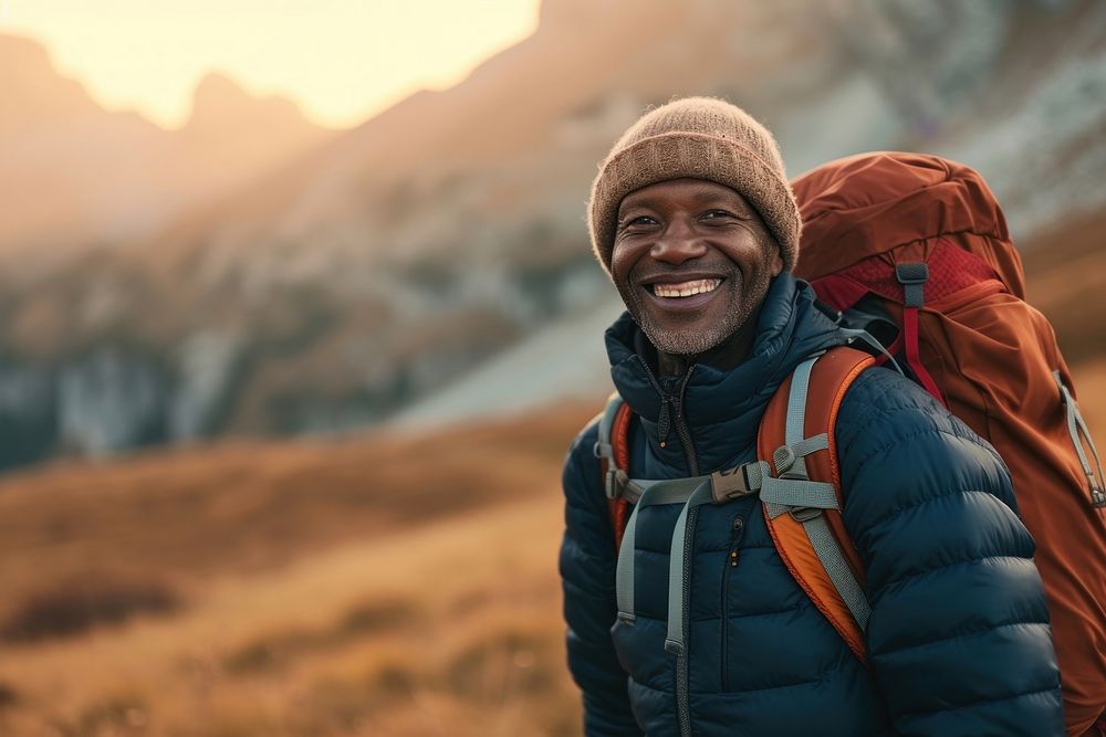 African middle age man hiking backpacking mountain smile.