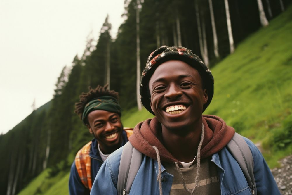 African Backpackers in Switzerland laughing outdoors plant.