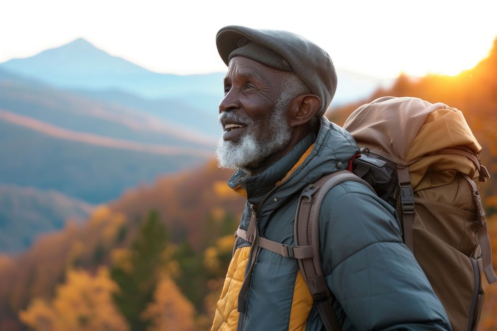 African senior man hiking backpacking adventure mountain.