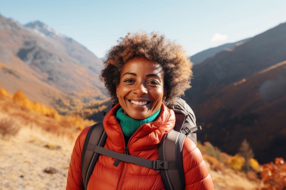 African middle age woman hiking mountain smiling autumn.
