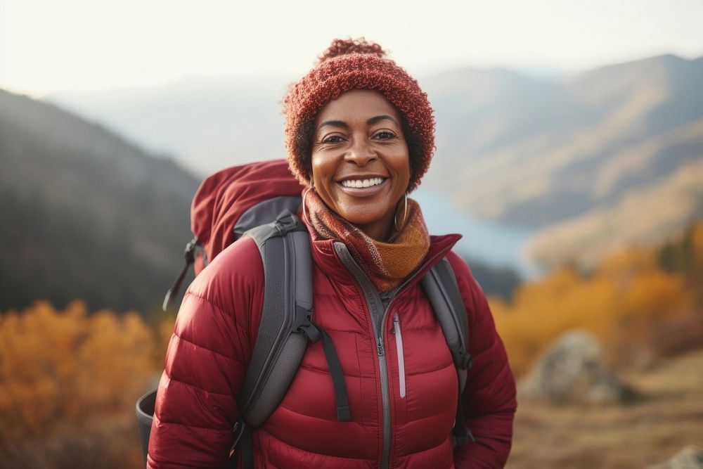 African middle age woman hiking adventure mountain backpack.