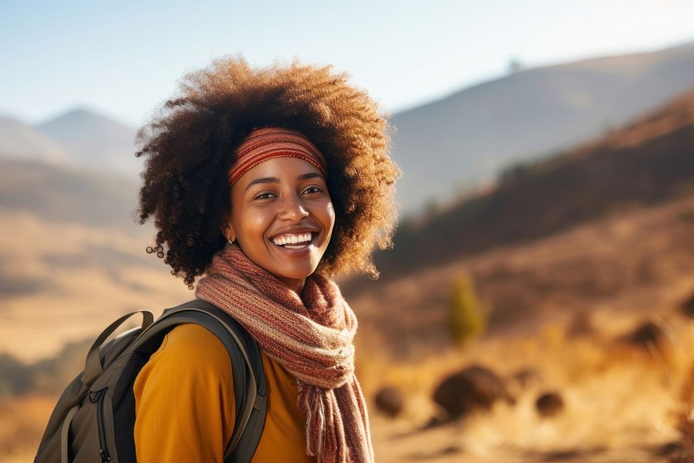 African woman hiking mountain smiling autumn.