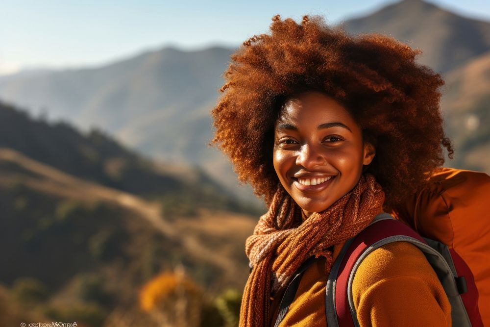 African woman hiking mountain portrait smiling.