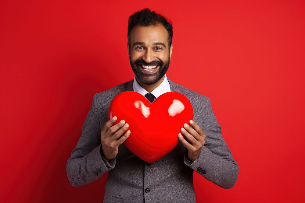 Indian male holding a heart adult love celebration.