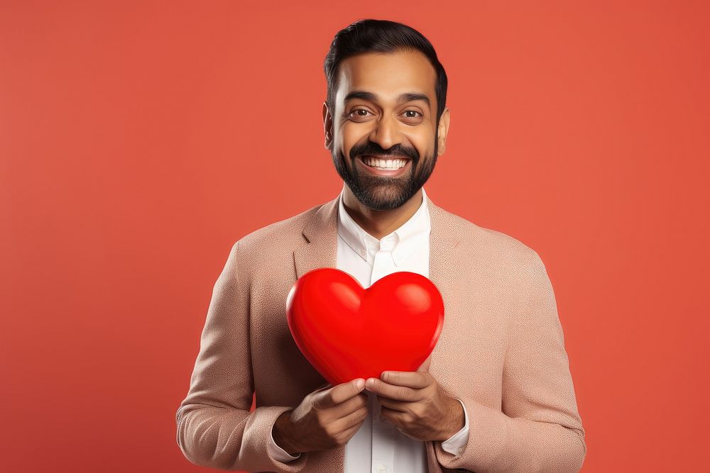 Indian male holding a heart adult love celebration.