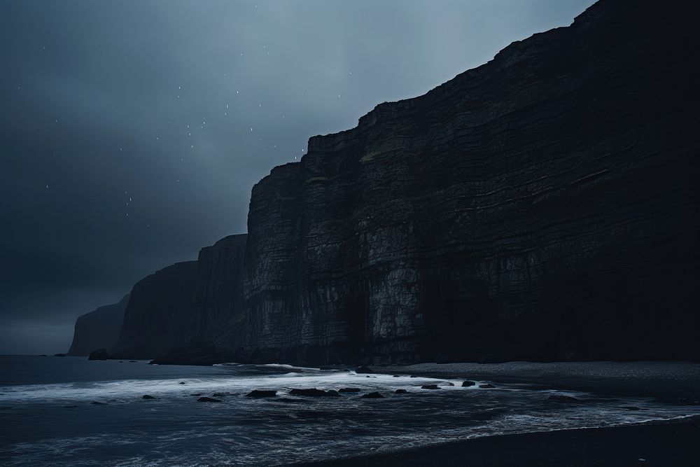 Dark background ocean cliff sky.