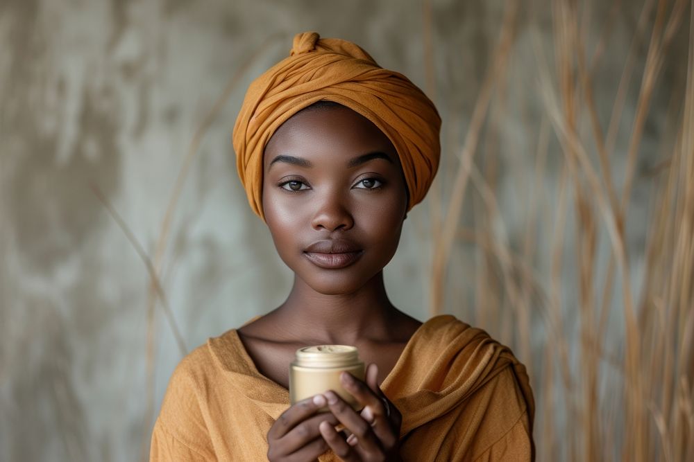 Black South African woman portrait holding turban.