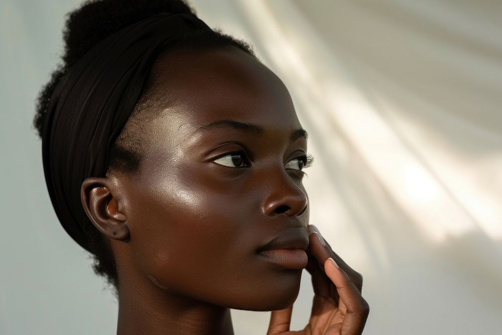 Black South African woman skin cosmetics applying.