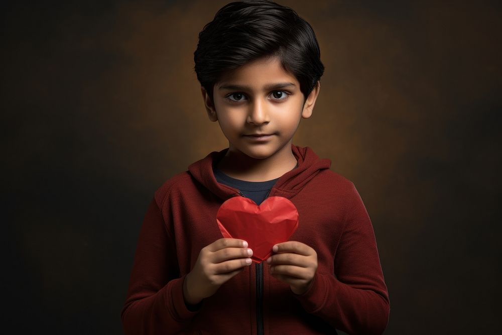 Indian kid holding red heart portrait child photo.