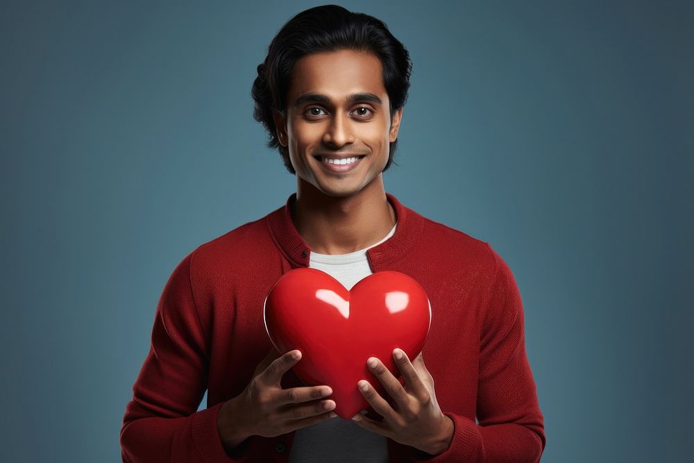 Indian man holding red heart happiness cheerful portrait.