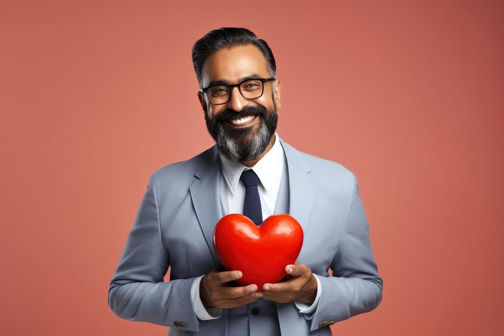 Indian man holding red heart adult celebration technology.