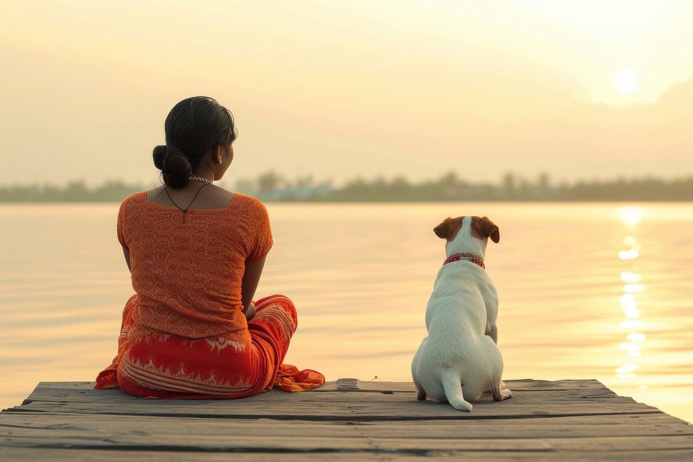 Indian Woman sitting with dog on jetty outdoors nature animal.