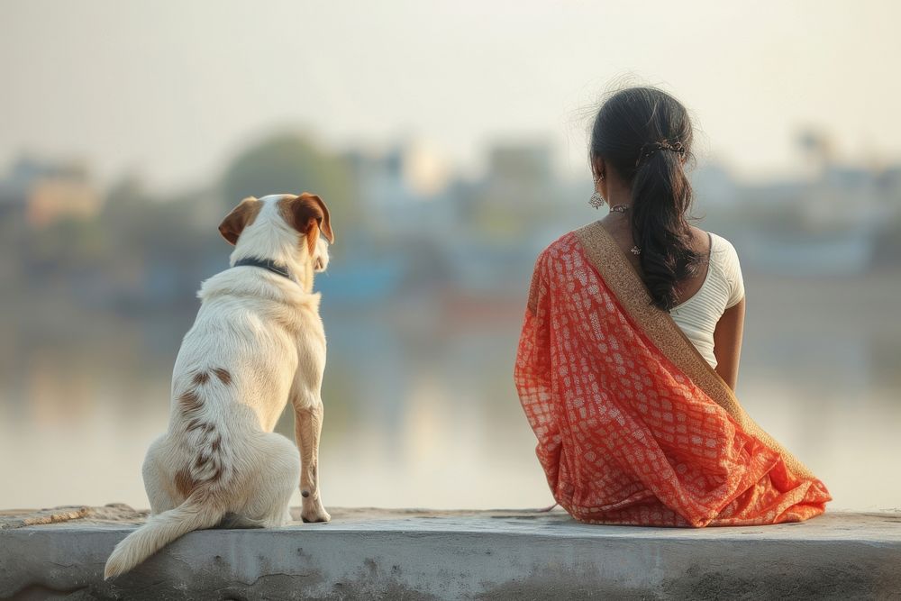 Indian Woman sitting with dog on jetty mammal animal adult.