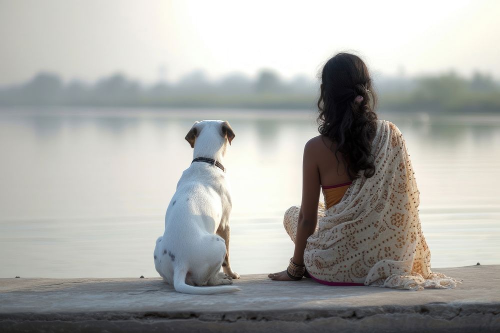 Indian Woman sitting with dog on jetty outdoors animal mammal.
