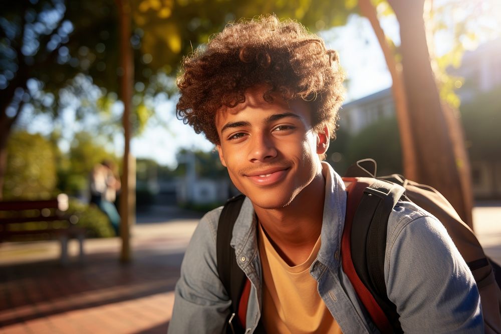 Brazilian teen student sitting on the bench portrait sunlight smile.