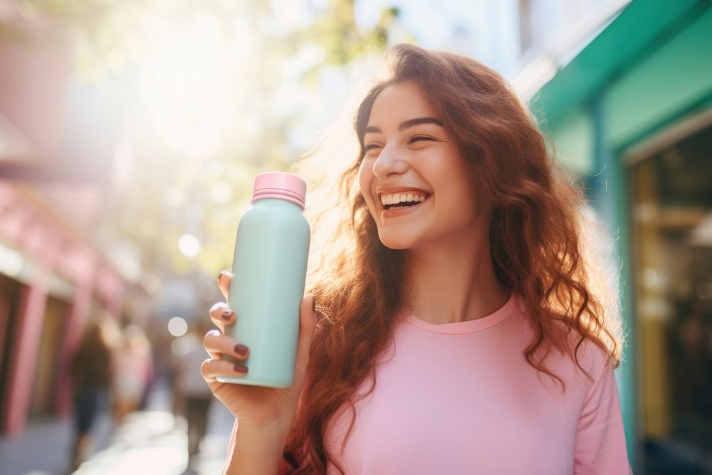 Happy women holding pastel color metal water bottle sunlight adult smile.