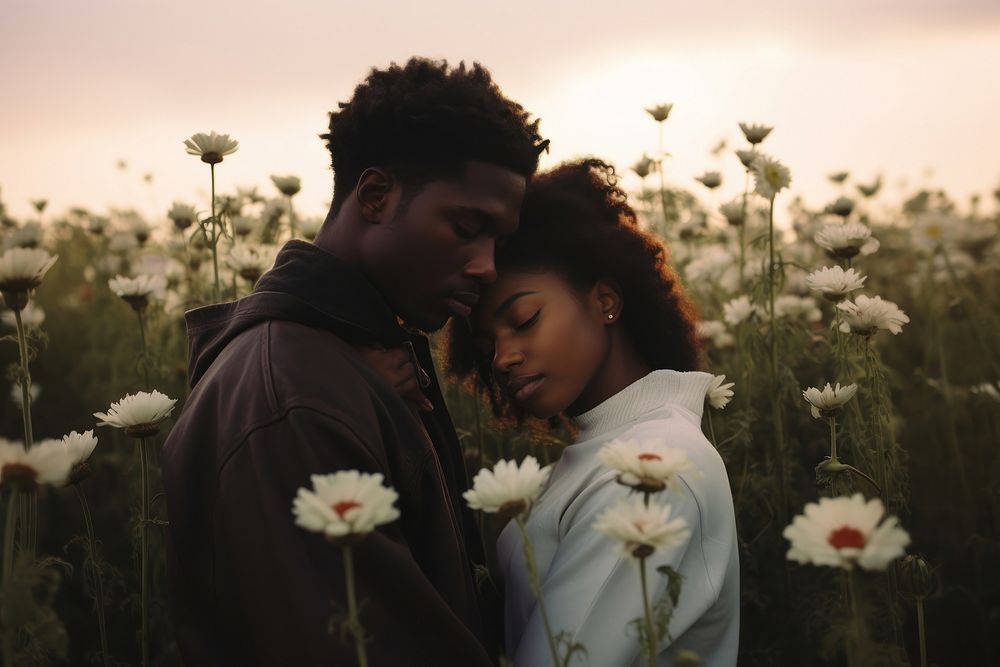 Black couple outdoors flower portrait.
