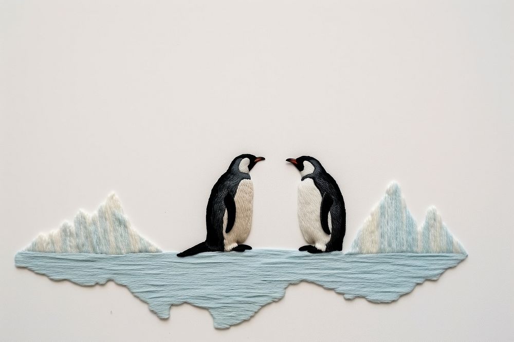 Penguins with iceberg in embroidery animal bird togetherness.