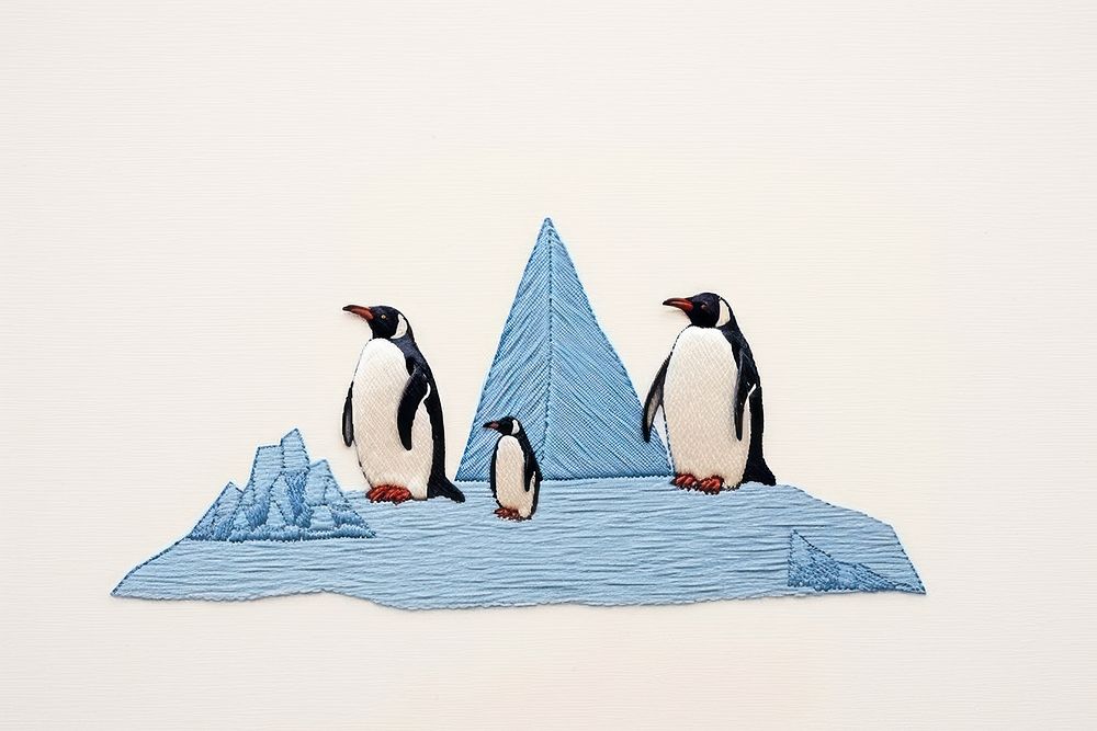 Penguins with iceberg in embroidery animal bird wildlife.