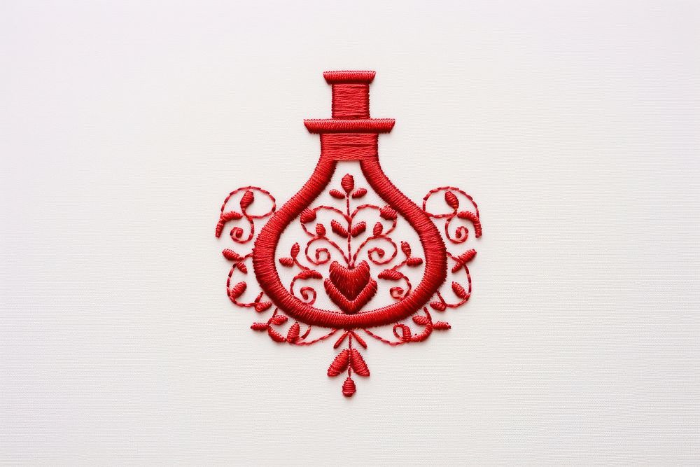 Perfume icon in embroidery pattern art creativity.