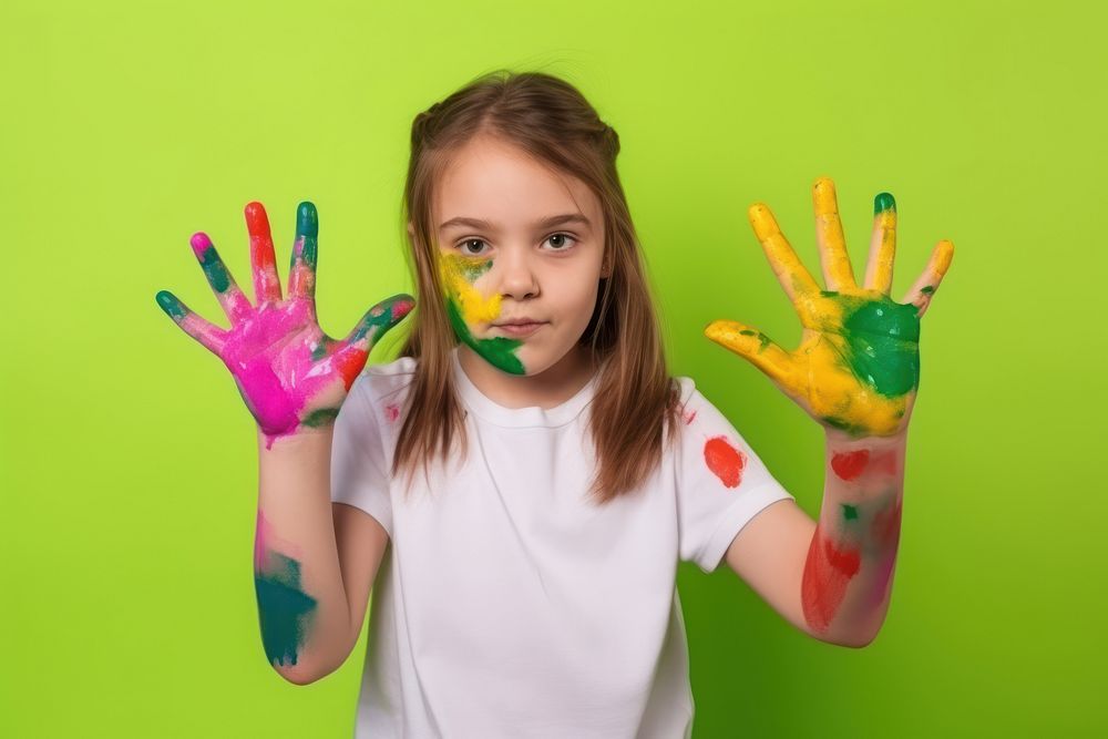Girl with a hand covered in paint portrait child cute. AI generated Image by rawpixel.
