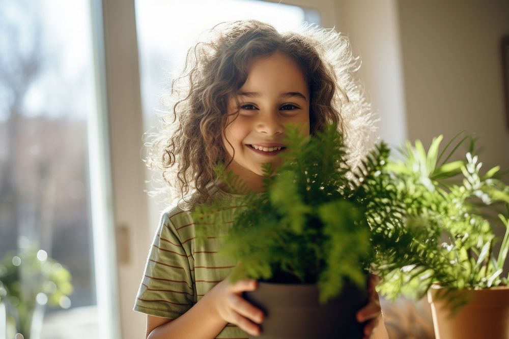 Girl holding plants smile portrait houseplant. AI generated Image by rawpixel.