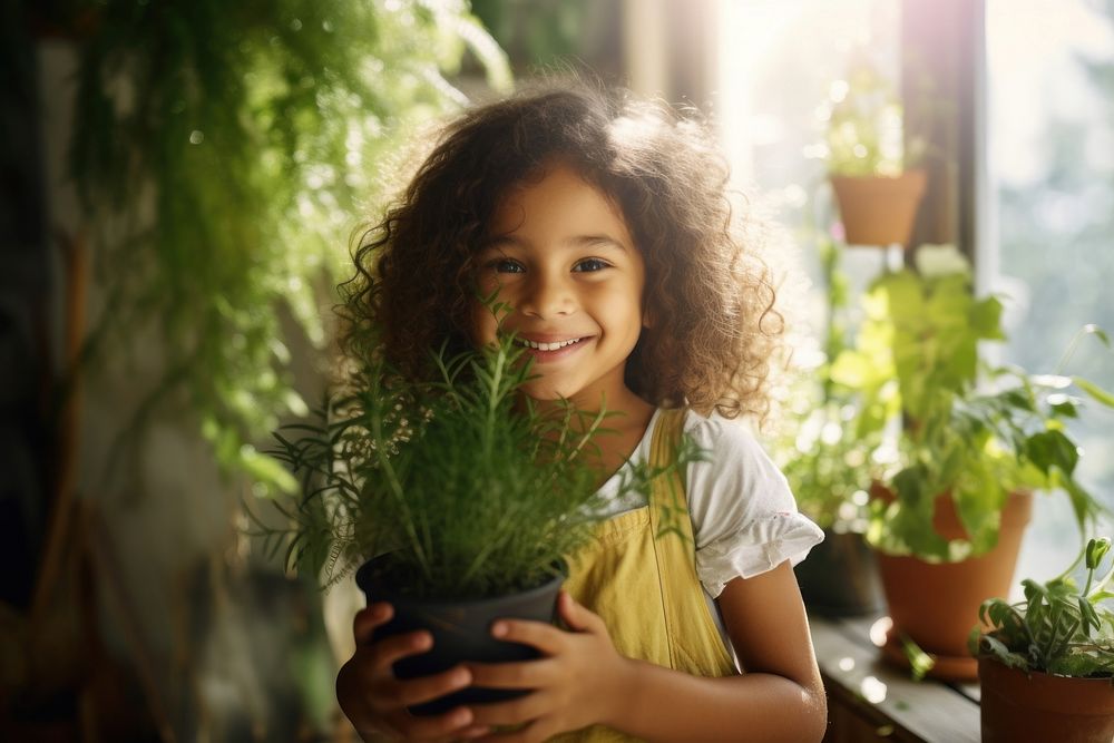 Girl holding plants smile portrait child. AI generated Image by rawpixel.