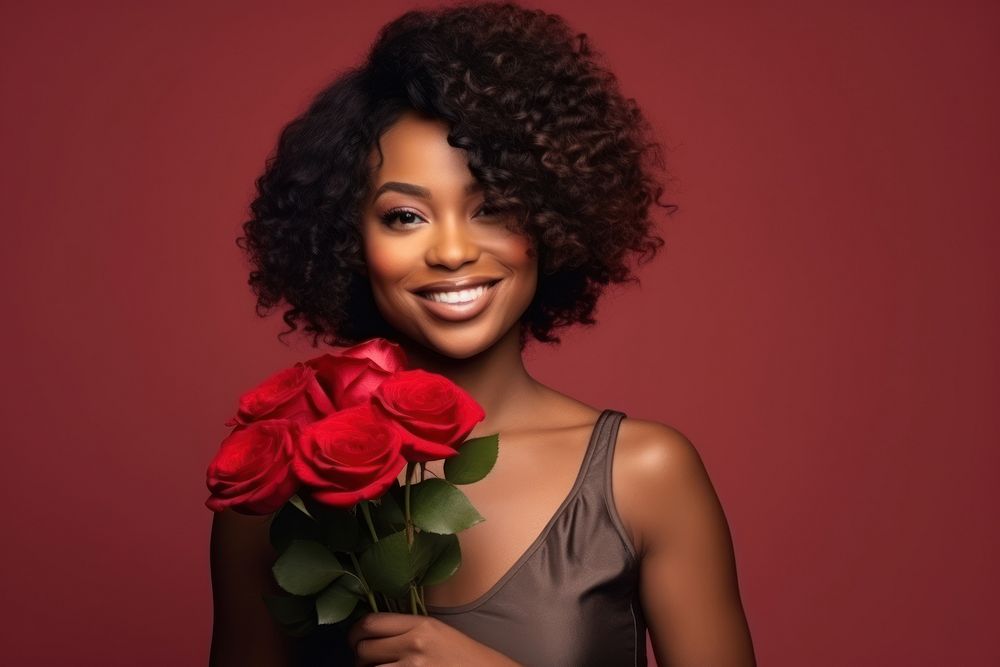 Black woman holding bouquet red rose portrait smiling adult.
