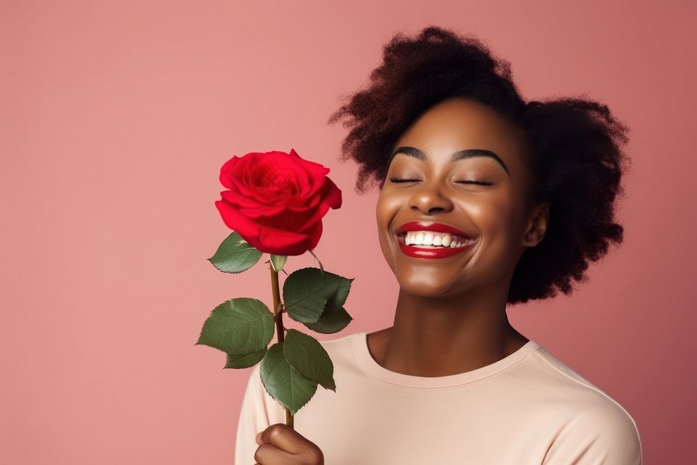 Black woman holding bouquet red rose portrait laughing smiling.