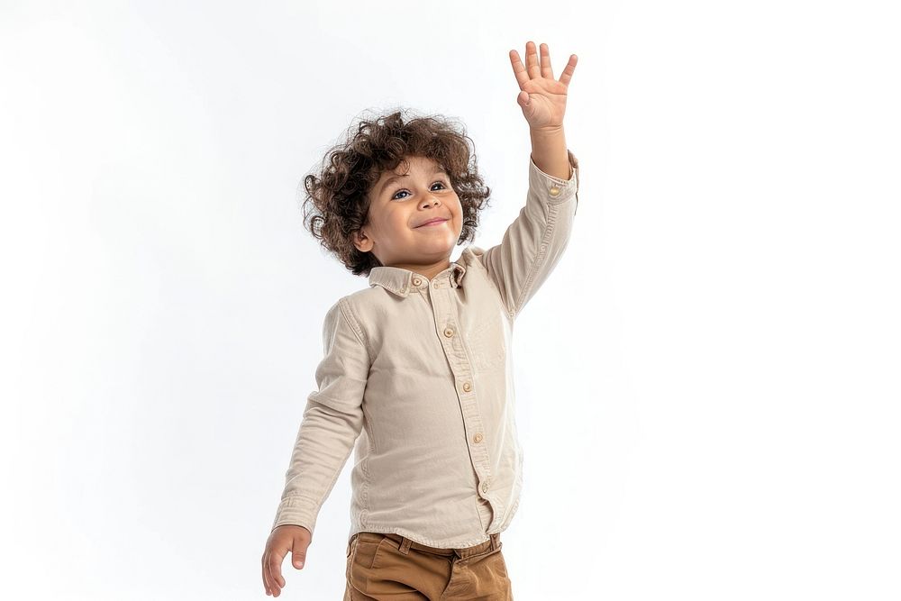 Middle eastern boy 6 years old happy raising her hand baby white background studio shot.