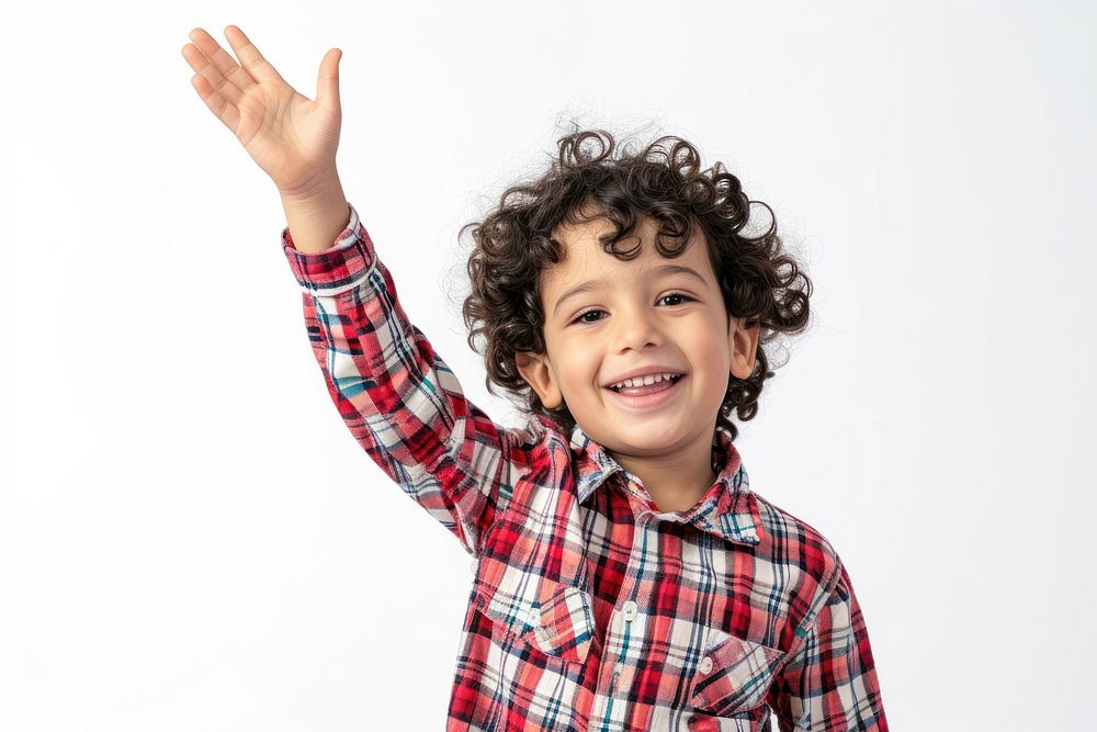 Middle eastern boy 6 years old happy raising her hand smile white background studio shot.