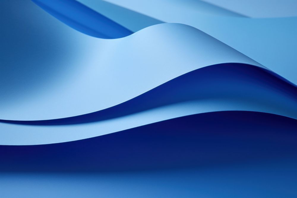 A blue folded paper artfully arranged on a table backgrounds abstract curve.
