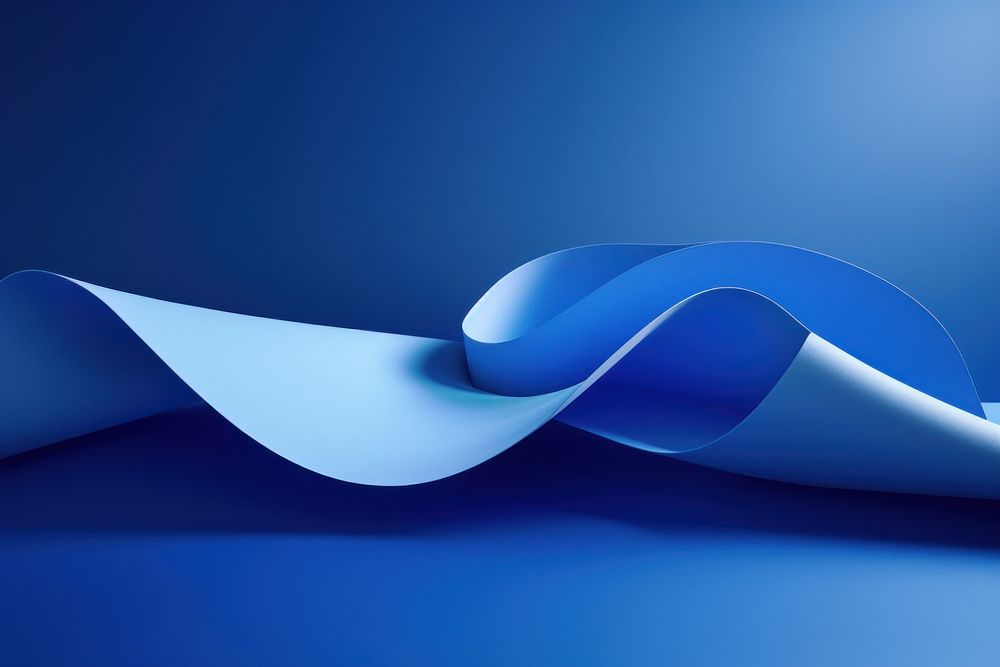 A blue folded paper artfully arranged on a table abstract curve line.