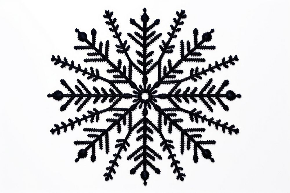 Black snowflake in embroidery style white creativity decoration.