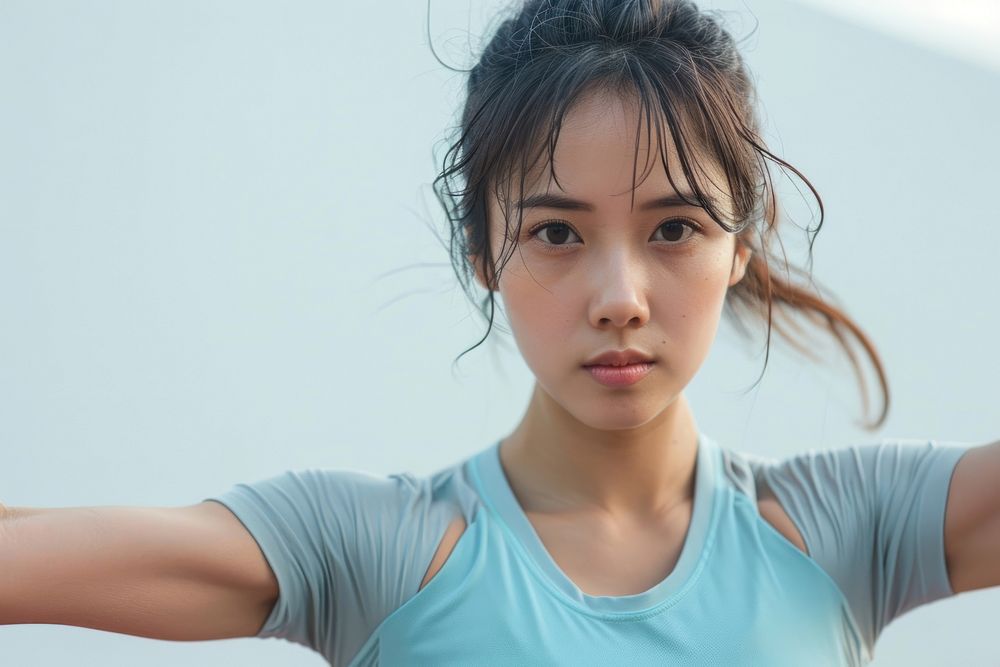 Asian woman in soft blue top exercise photo determination contemplation.
