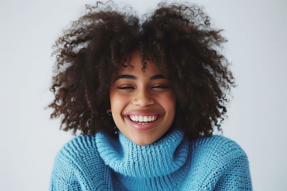 South african woman with a wig and curly hair sweater laughing adult.