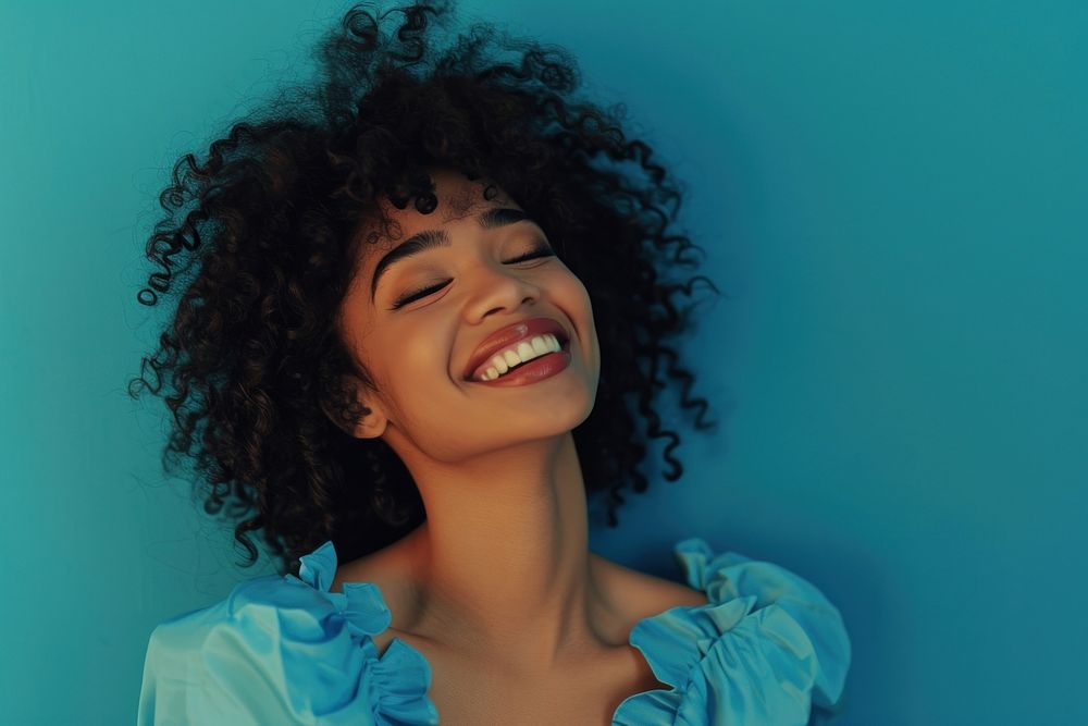 South african woman with a wig and curly hair wearing blue dress laughing smile adult.