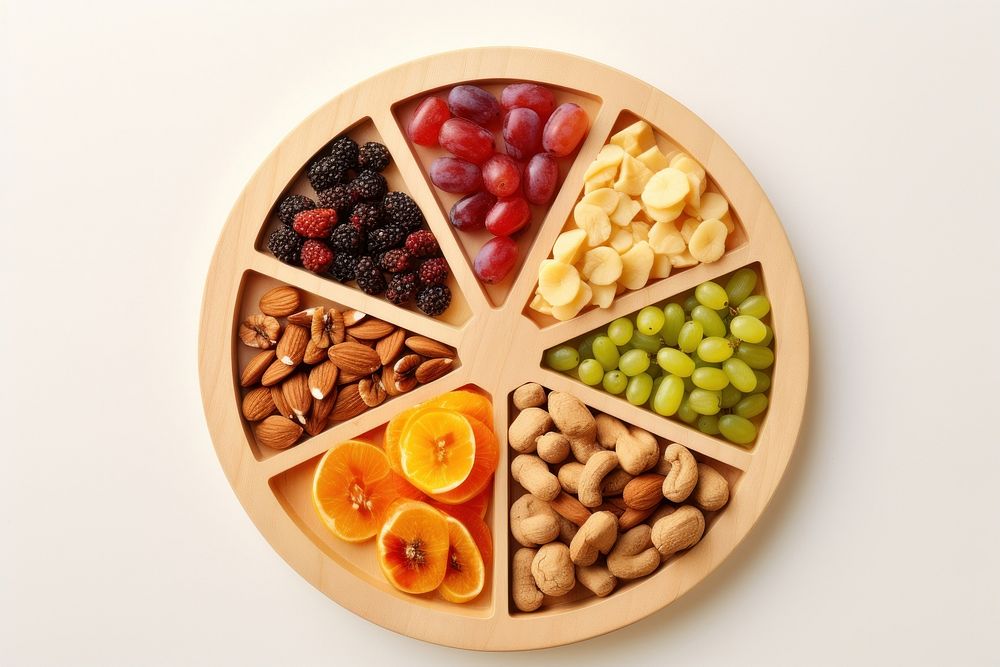 Partition wooden plate with cut fruits and nuts food medication blueberry.