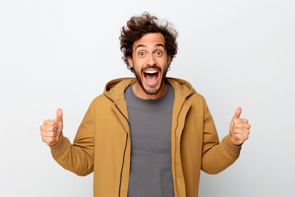 Young caucasian handsome man surprised and smiley Raise your hand shouting adult white background.