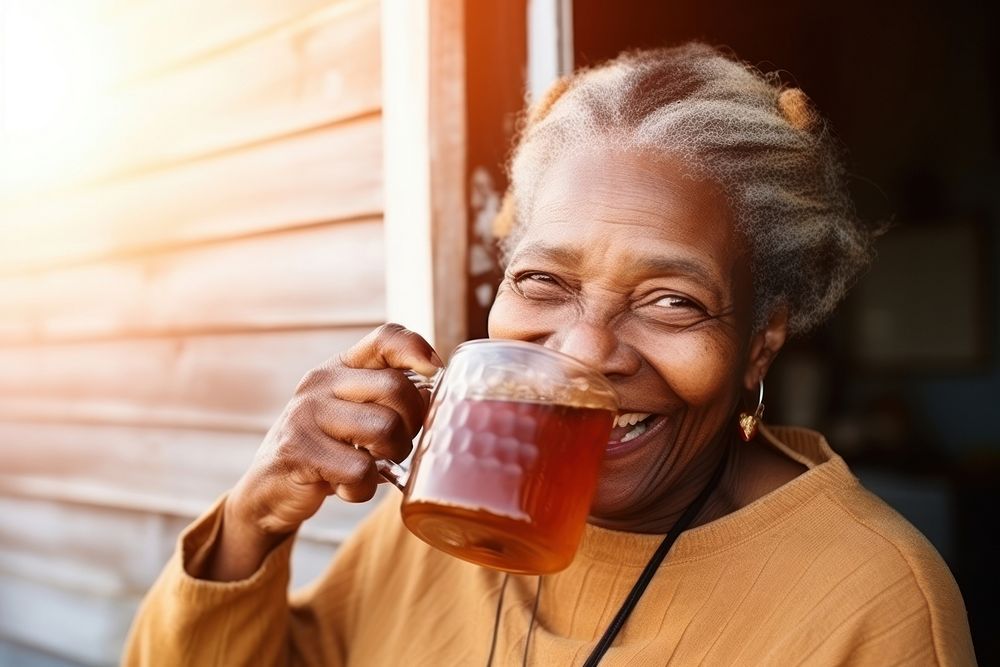 African American old woman drinking smiling adult.