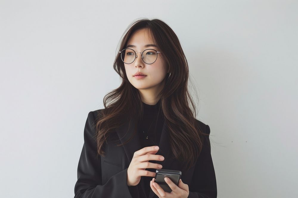 Asian business woman in glasses holding a cell phone portrait adult photo.
