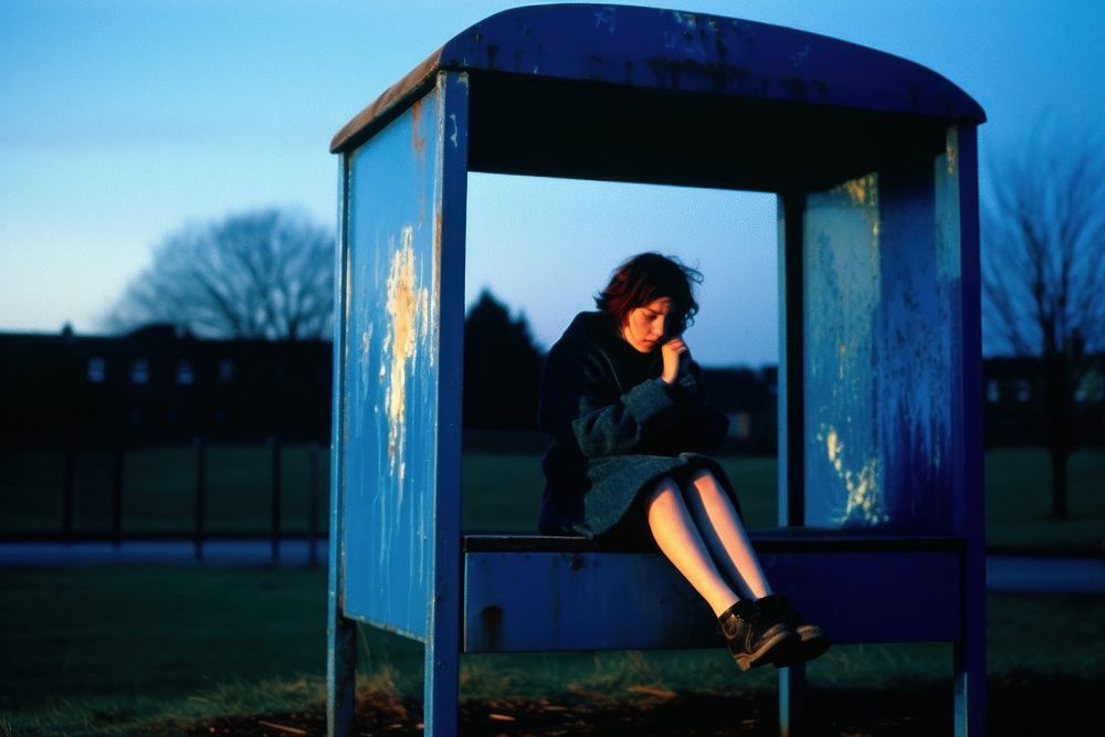 Girl outdoors sitting blue.