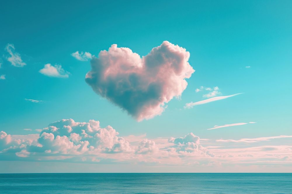 Heart shaped clouds in the sky over the sea outdoors nature tranquility.