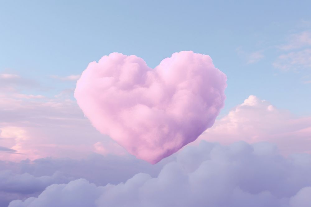 Heart shaped as a pink cloud pattern in the pink sky background outdoors nature tranquility.