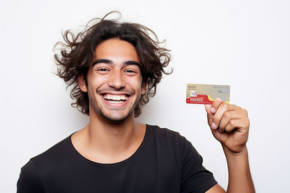 Man holding credit card smiling white background hairstyle.