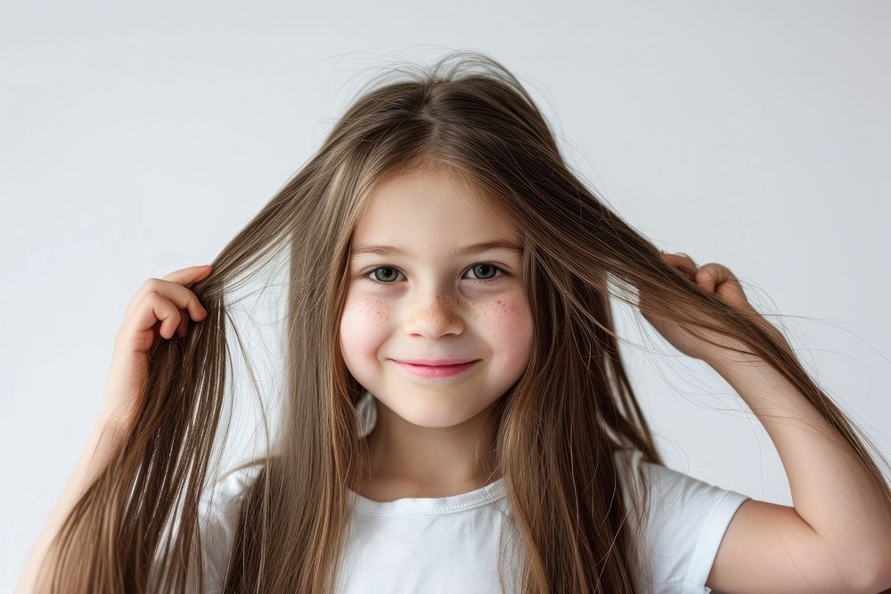 Young girl tying her long hair portrait smile happy.