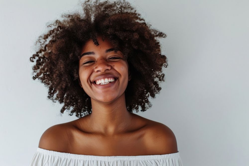 Afican american woman with white top laughing portrait adult smile.
