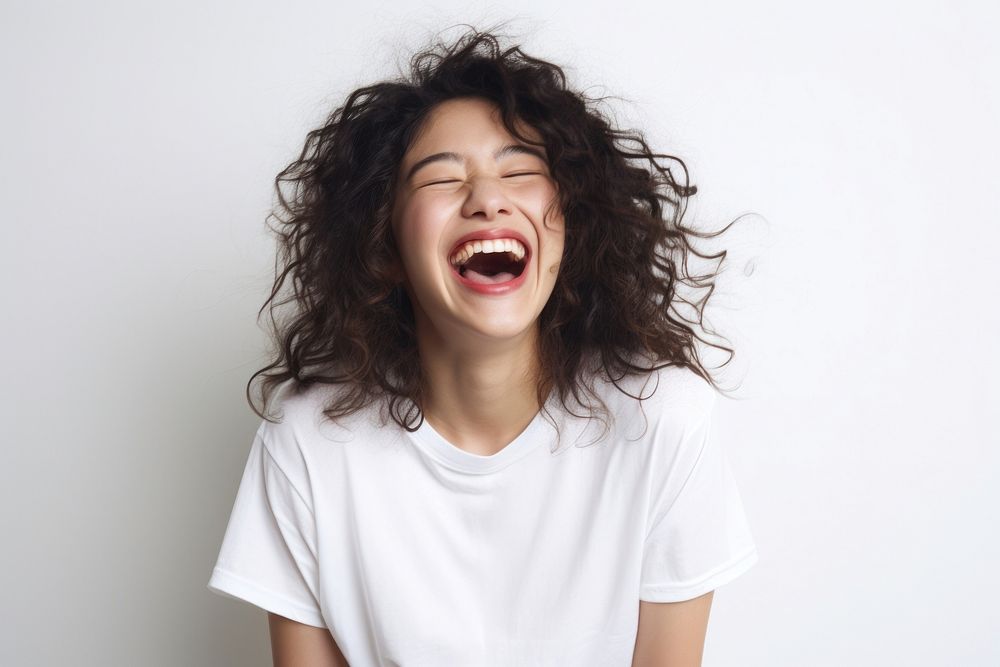 Asian woman with white top laughing shouting adult face.