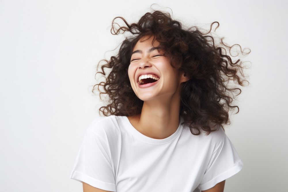 Asian woman with white top laughing face white background excitement.